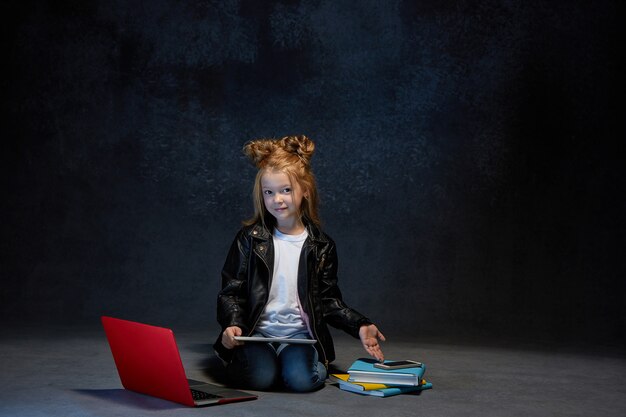 Little girl sitting with gadgets