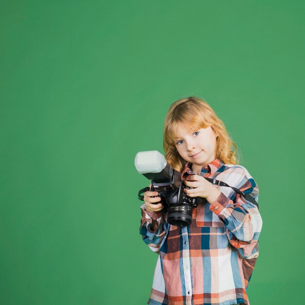 Little girl standing with camera