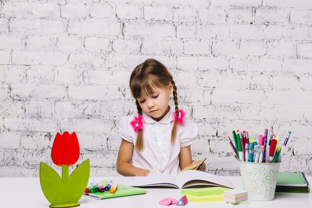 Little girl at table doing homework