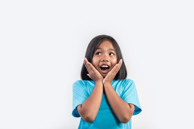 Little girl thinking in studio shot