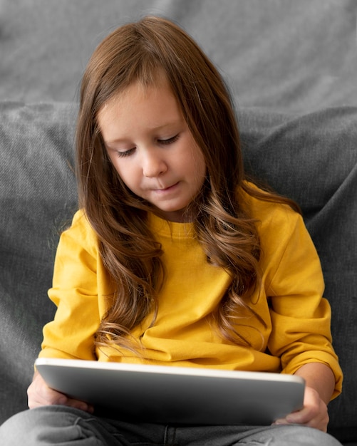 Free photo little girl using tablet