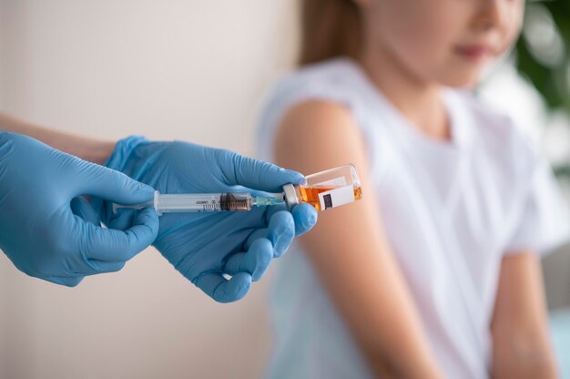 Little girl vaccinating for coronavirus at the hospital