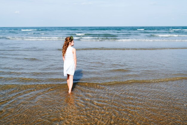 Little girl walking in the water