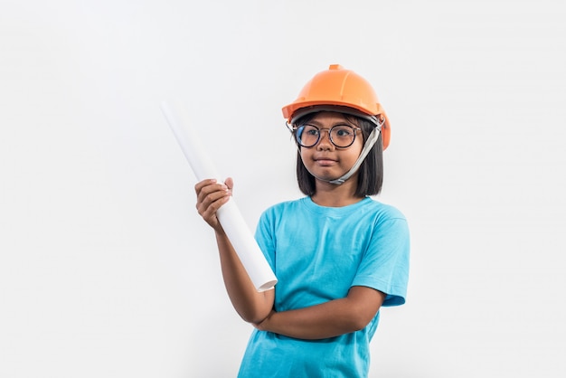 Little girl wearing orange helmet in studio shot