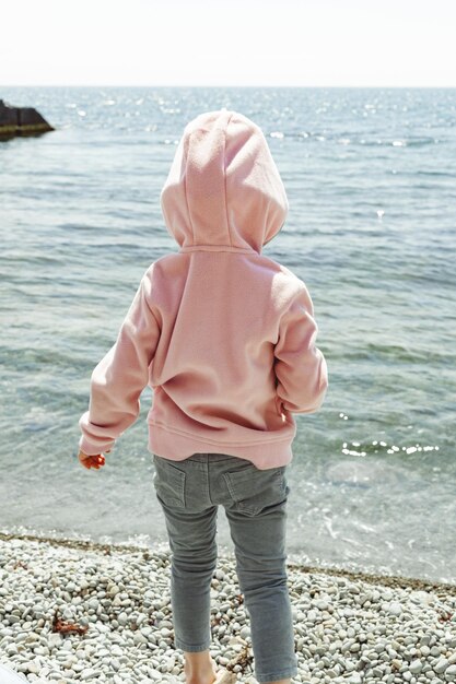 Little girl wets her feet in the sea