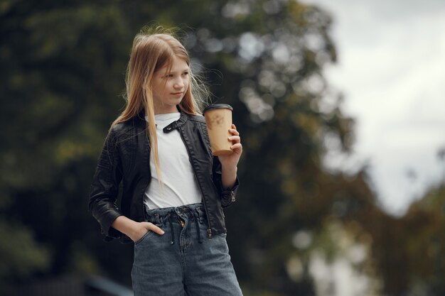 Little girl in a white t-shirt in a summer city