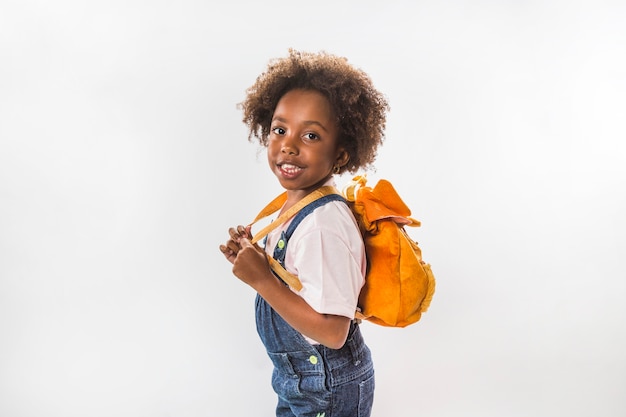 Little girl with backpack in studio