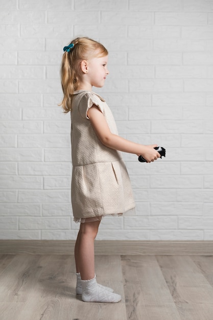 Little girl with joystick at home