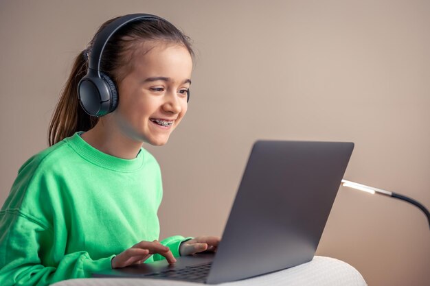 Little girl with laptop plays games concept of game addiction