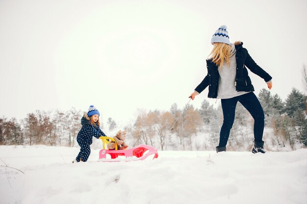 겨울 공원에서 노는 어머니와 어린 소녀