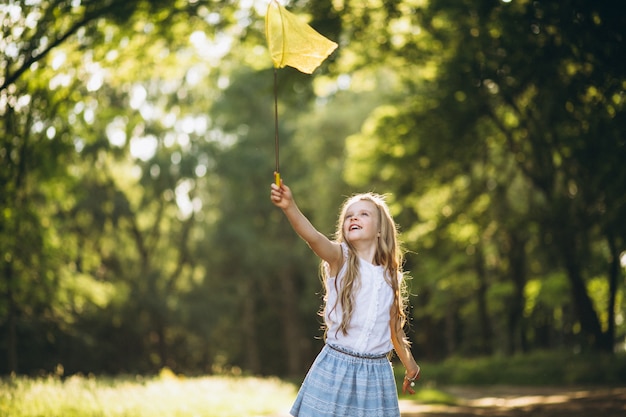 Little girl with net catching butterflies