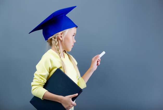 Little girl writing on blackboard