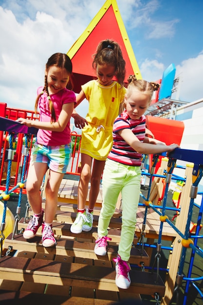 Little girls crossing the bridge without falling