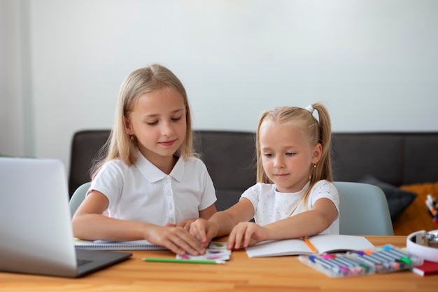 Little girls doing online school together
