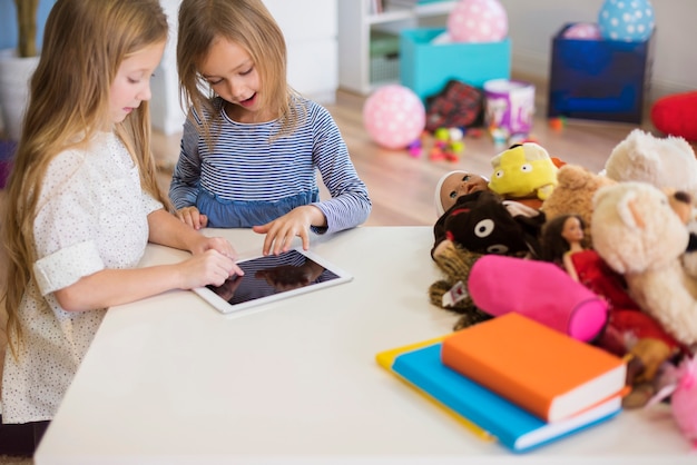 Little girls focused on interesting video game