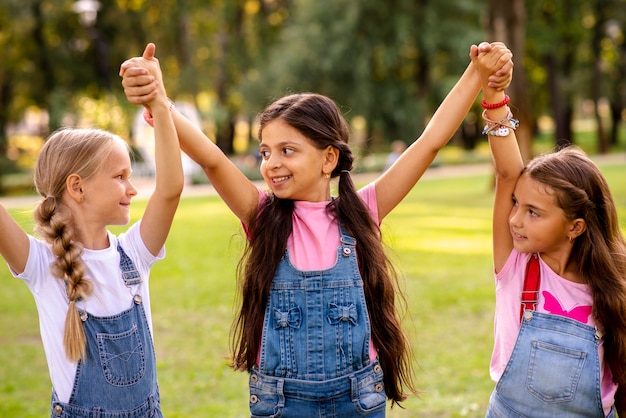 Free photo little girls holding hands in the air