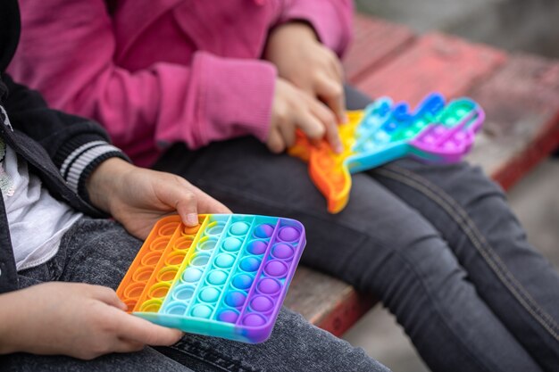 Little girls playing a new fidget toy popular with children helps them to concentrate