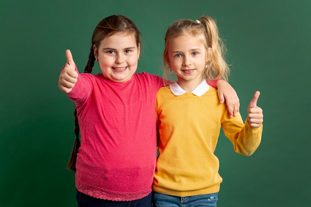 Free photo little girls showing ok sign
