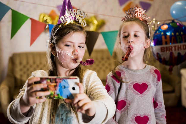 Little girls taking selfie on party