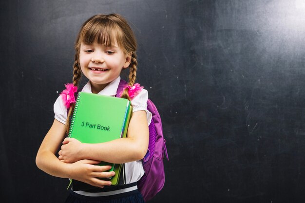 Little girls with backpack and books