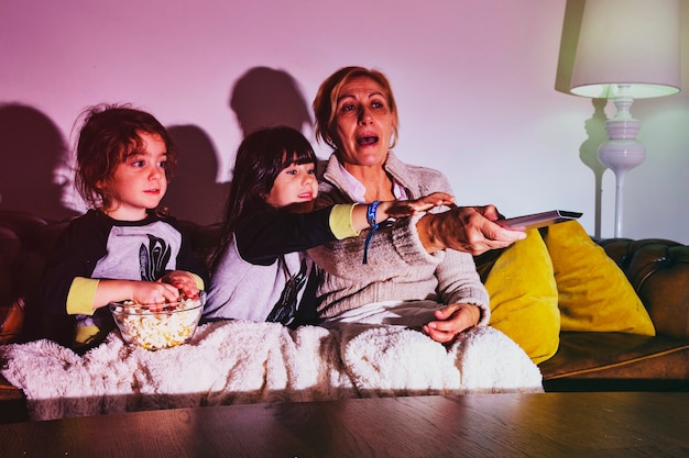 Little girls with mother watching TV