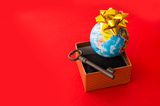 Free photo little global map with bow near present box and key