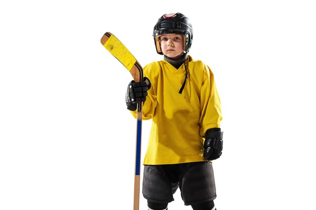 Little hockey player with the stick on ice court and white 