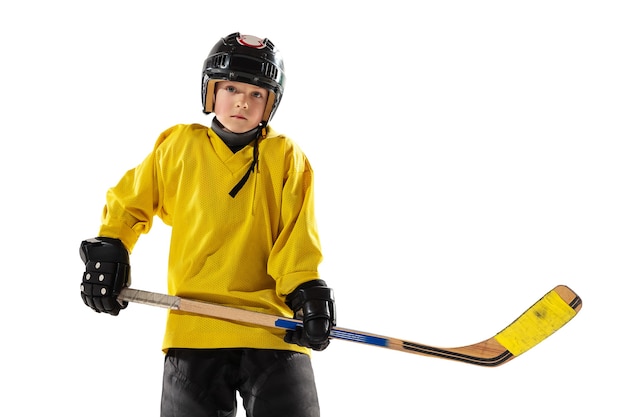 Little hockey player with the stick on ice court