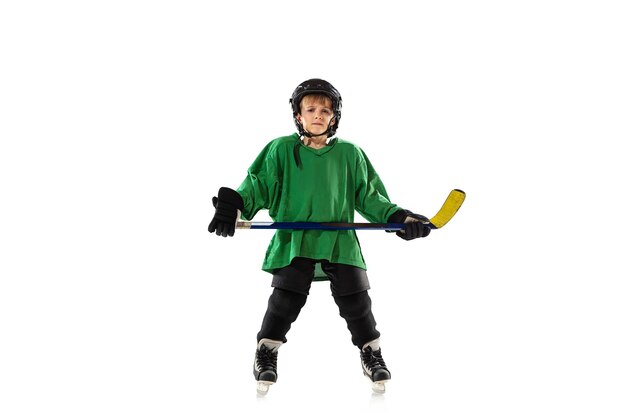 Little hockey player with the stick on ice court