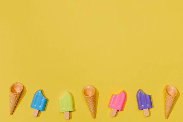 Little ice-creams on yellow surface