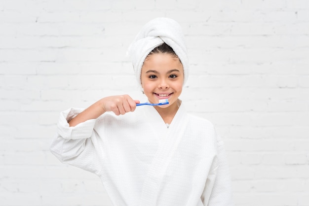 Little kid brushing her teeth