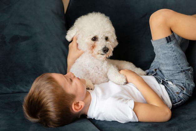 Little kid having fun with his dog