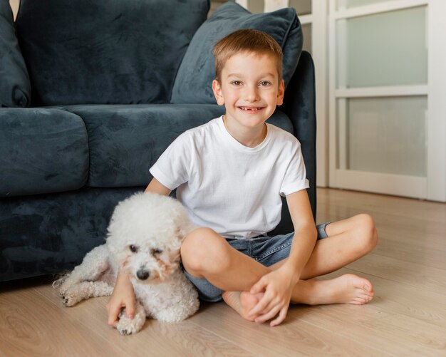 Little kid posing with his dog