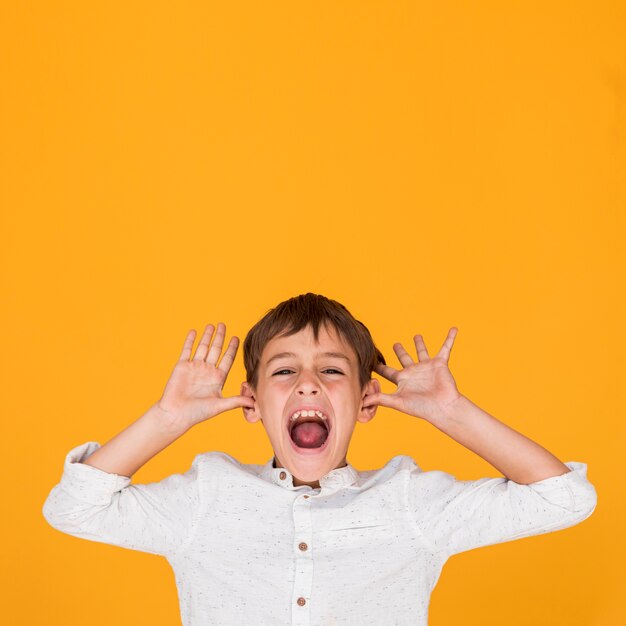 Little kid shouting with copy space