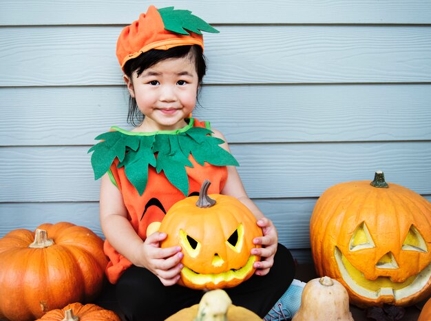 Little kid with Halloween pumpkin