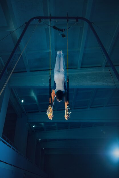 Little male gymnast training in gym flexible and active