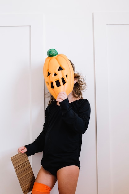 Little pumpkin holding cardboard