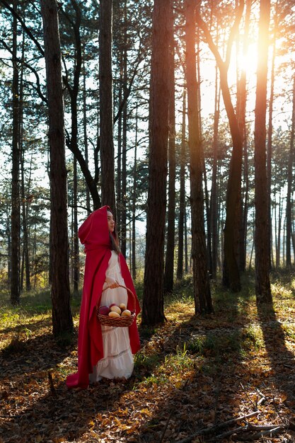 Little red riding hood with wooden basket with goodies