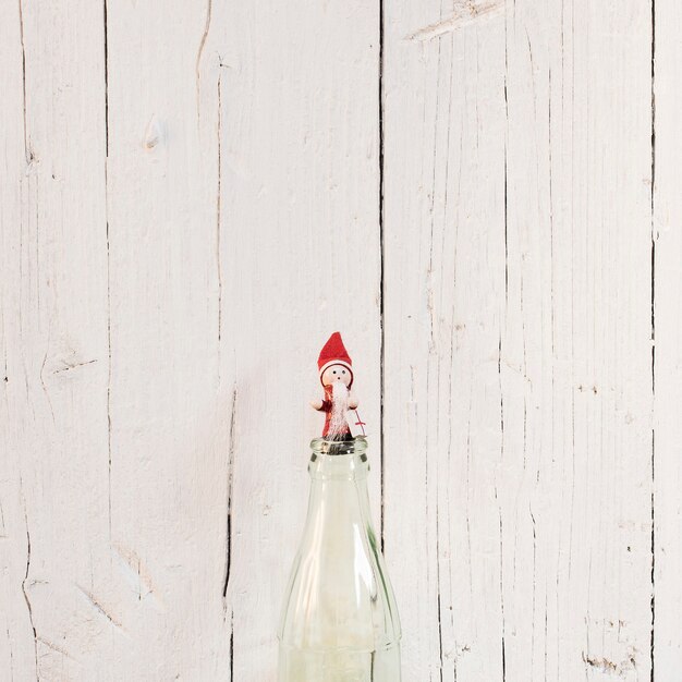 Little Santa Claus with white wooden background