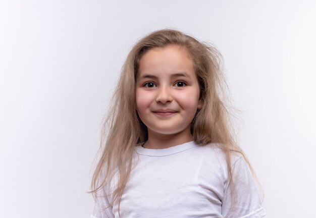 little school girl wearing white t-shirt on isolated white wall