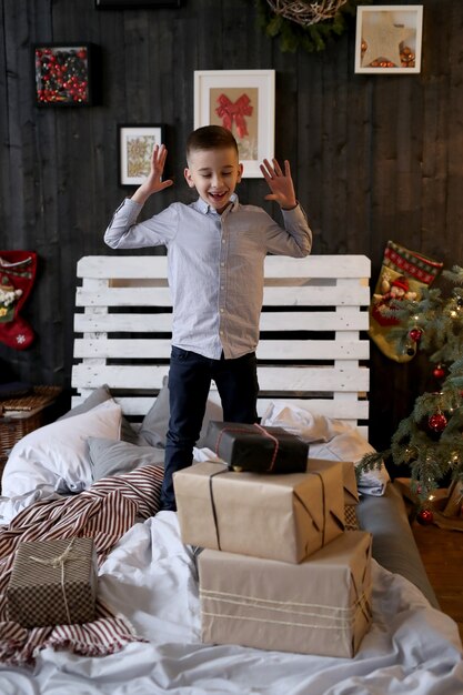 Little shocked boy with Christmas presents