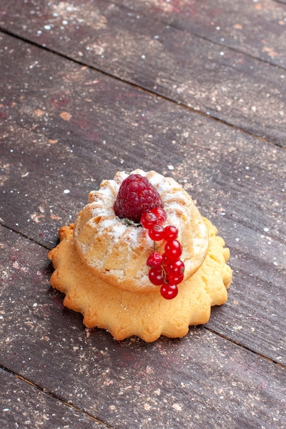 little simple cake with sugar powder raspberry and cranberries on wooden rustic,  berry fruit cake sweet