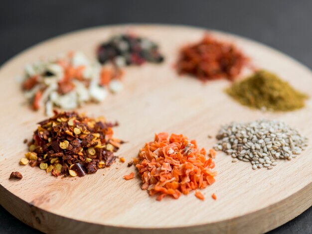 Little spice piles on wooden tray