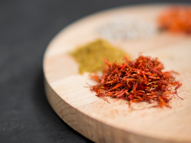 Little spice piles on wooden tray