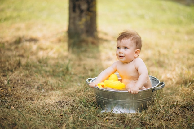 Little toddler boy bathing in park