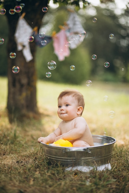 Little toddler boy bathing in park