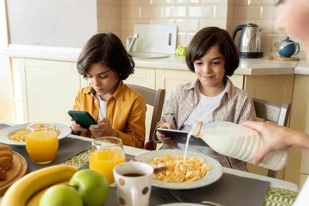 Little twins playing on different devices