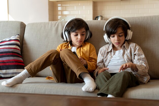 Little twins playing on their tablet