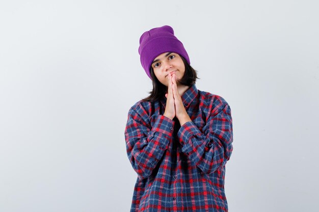 Little woman showing clasped hands in pleading gesture