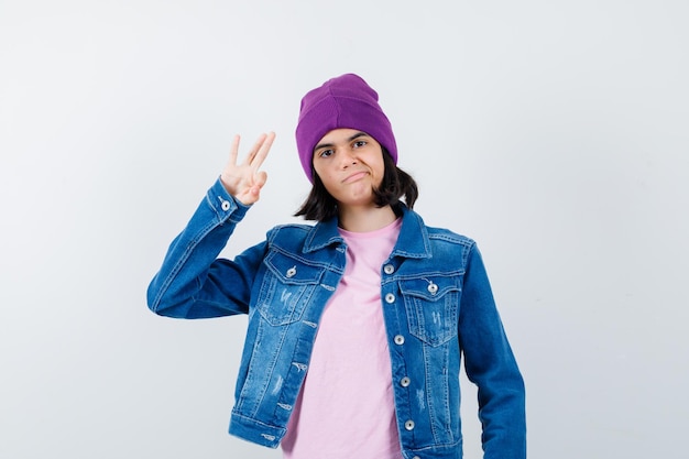 Little woman showing ok gesture in t-shirt denim jacket looking confident